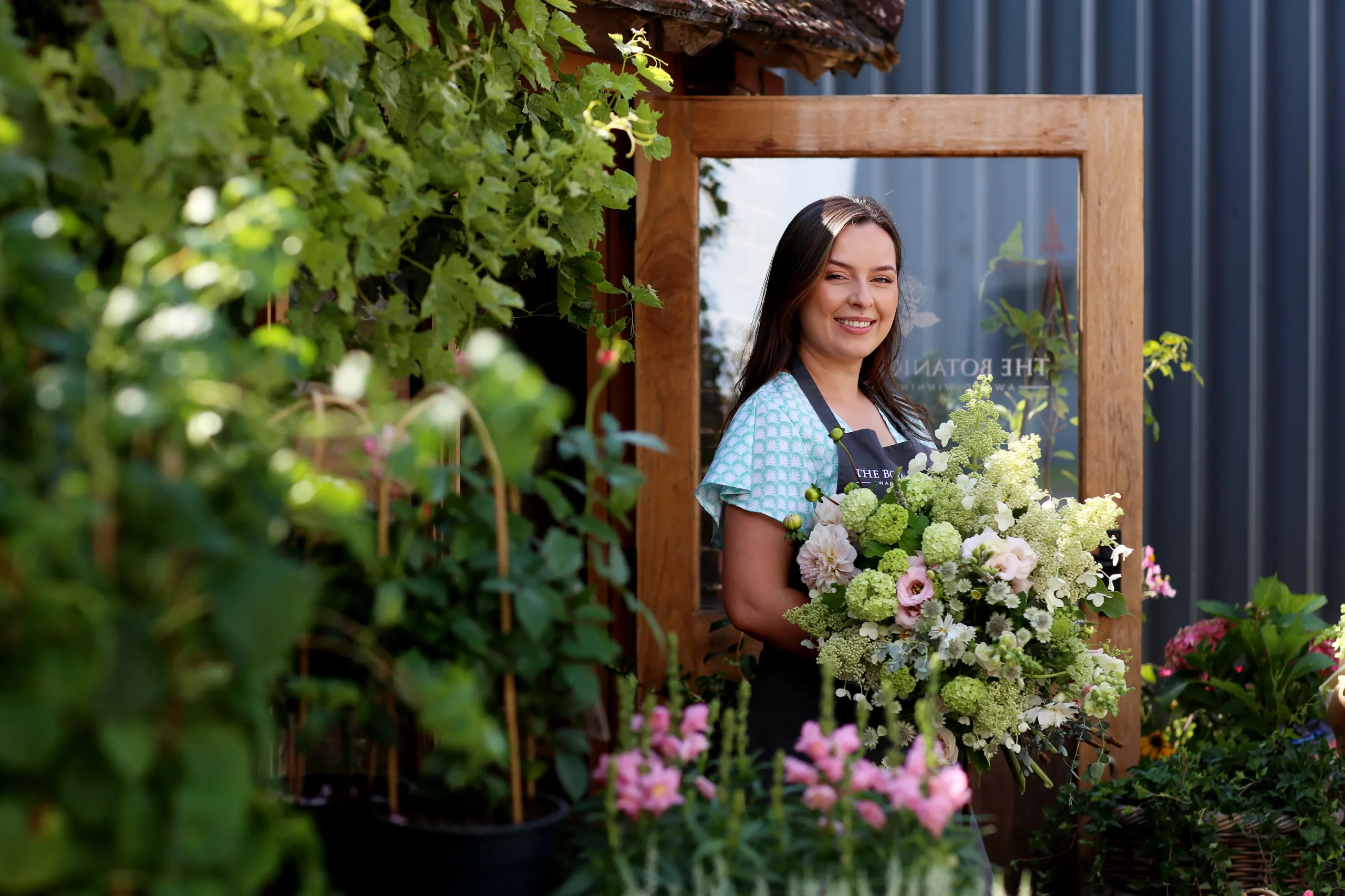 Elizabeth Newcombe crafting custom floral designs at The Botanical Co. studio in Hambledon