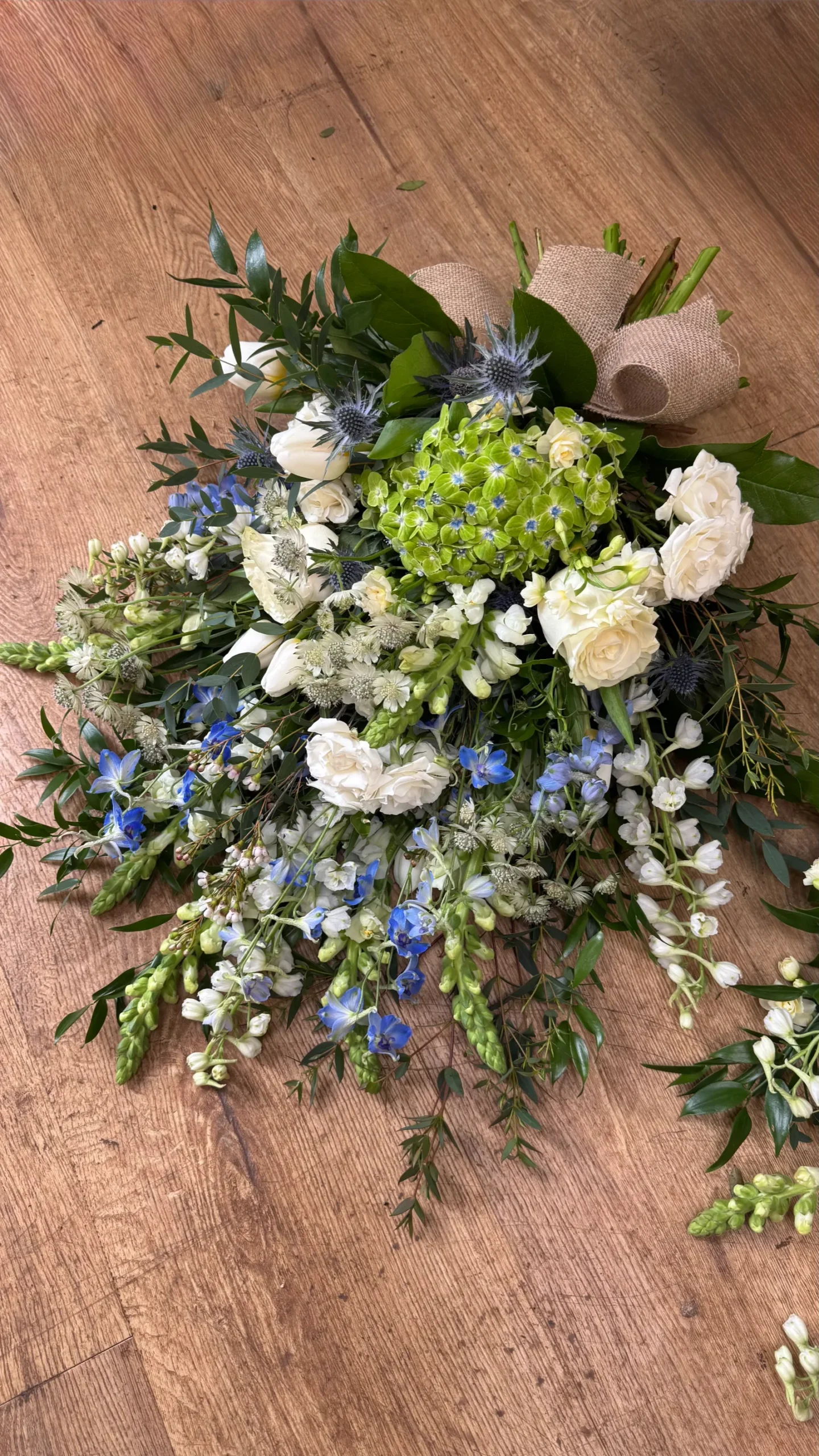 Blue and white tied sheaf funeral tribute