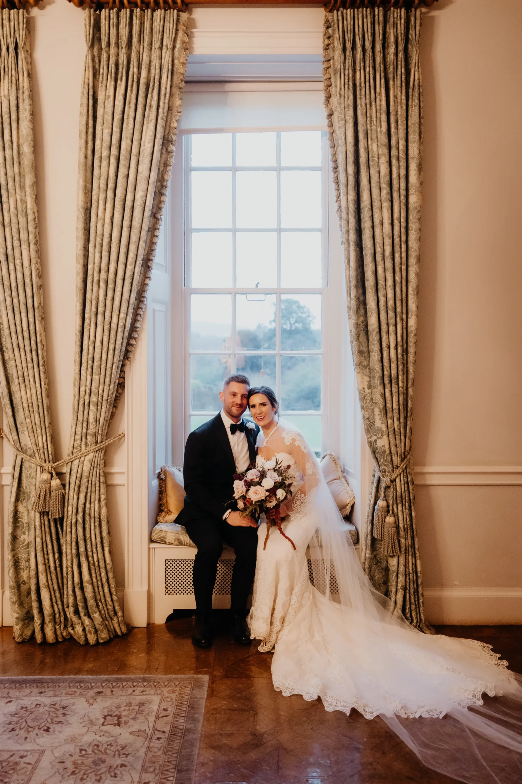 India and Will at Cowdray House with winter floristry by The Botanical Company